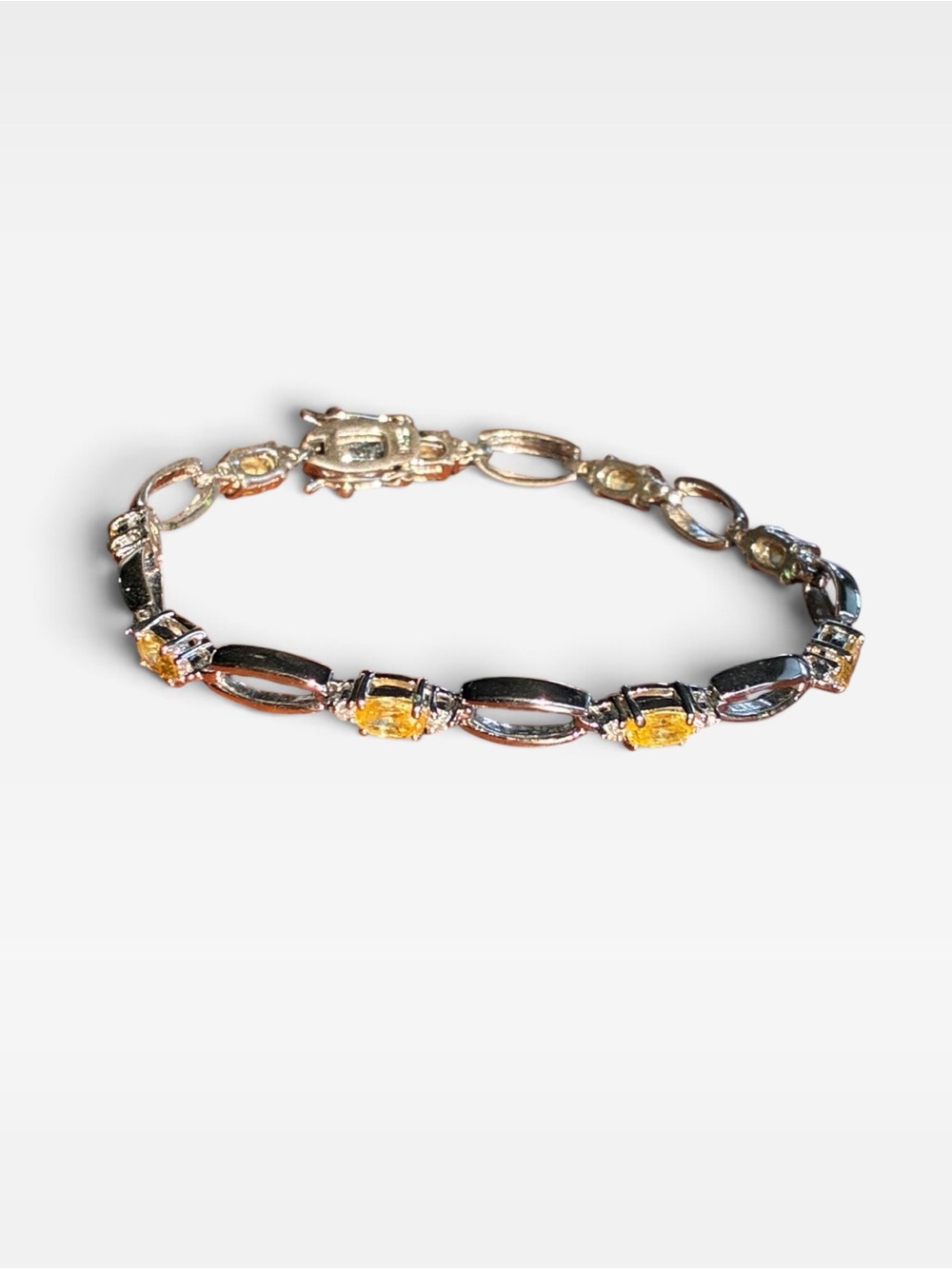.825 Silver Link Bracelet with Yellow Gemstones and Crystals.